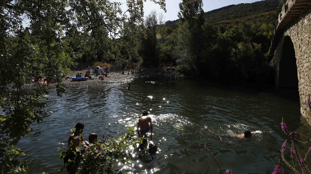Un grupo de personas disfruta de un baño en el río Arga en la localidad navarra de Irozt, en una jornada con buen tiempo y altas temperaturas. EFE/Jesús Diges