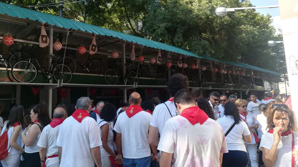 Gente de blanco y rojo espera la cola en la Tómbola 2018 en San Fermín. NAVARRA.COM