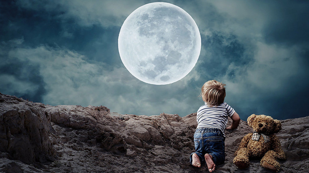 Un niño observa la luna.