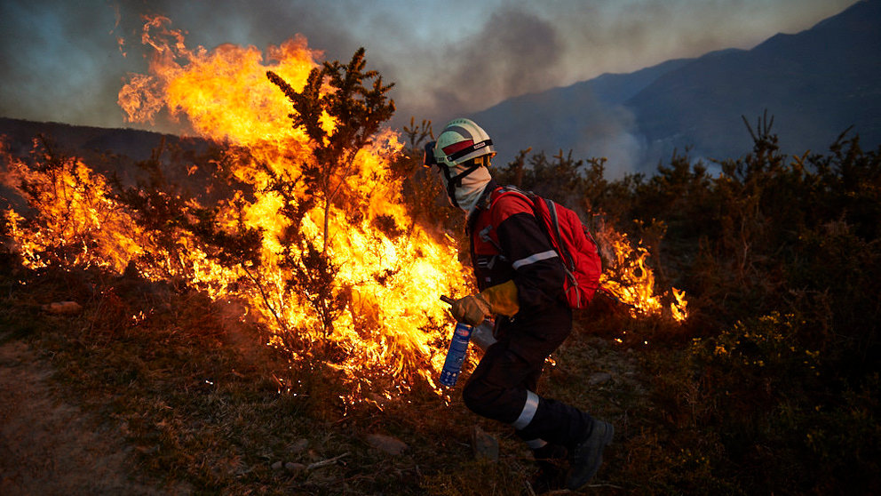 Los bomberos de Oronoz Mugaire sofocan un incendio en un monte cerca de Arraioz. MIGUEL OSÉS 2