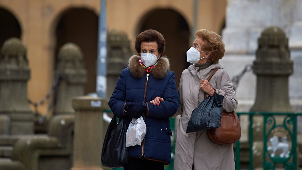 Dos señoras caminan por las calles de Pamplona en el invierno de la pandemia por coronavirus. MIGUEL OSÉS