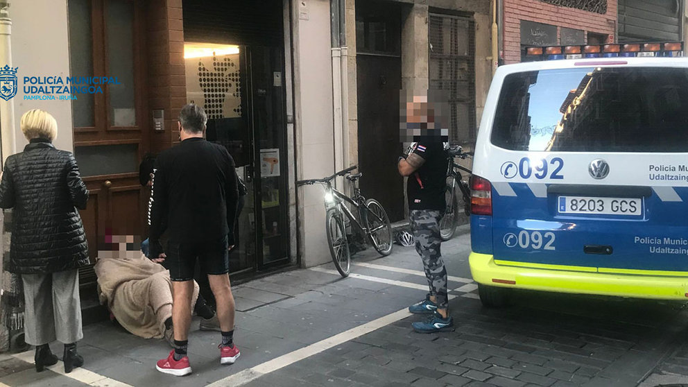 Agentes de la policía de Pamplona atienden al hombre que ha sido atropellado por una bicicleta en la calle Mayor. POLICÍA MUNICIPAL DE PAMPLONA
