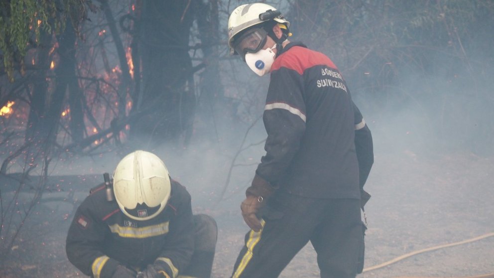 Dos bomberos en plena acción. Han tenido que emplearse a fondo. EDUARDO SANZ / Europa Press