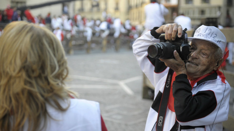 Bullfight photographer Francisco Cano, Canito, takes a picture of a television presenter at Telefonica Corner before the second running of the bulls of the San Fermin festival in Pamplona July 8, 2011.