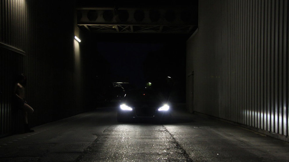 Imagen de un coche con las luces encendidas aparcado en un callejón ARCHIVO