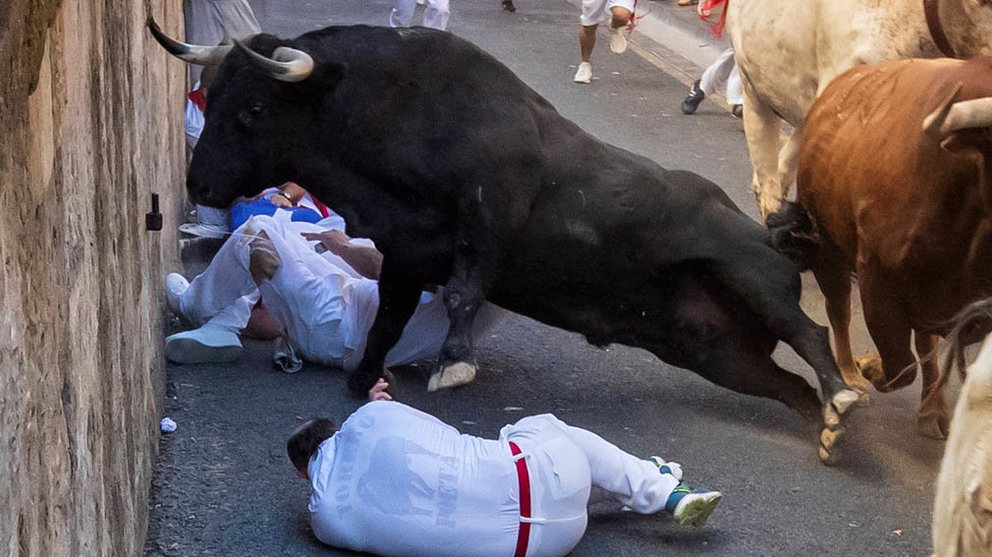Pamplona (Spain), 12/07/2019.- Bull runner and fighting bulls from the ranch of Nunez de Cuvillo run on the old city streets in Pamplona, northern Spain in the sixth 'encierro,' or running-with-the-bulls, during the Sanfermines festivities in Pamplona, Spain, 12 July 2019. The festival of San Fermin, locally known as Sanfermines, is held annually from 06 to 14 July in commemoration of the city's patron saint. Hundreds of thousands of visitors from all over the world attend the fiesta. Many of them physically participate in the highlight event - the running of the bulls, or encierro - where they attempt to outrun the bulls along a route through the narrow streets of Pamplona's old city. (España, Estados Unidos) EFE/EPA/JIM HOLLANDER
