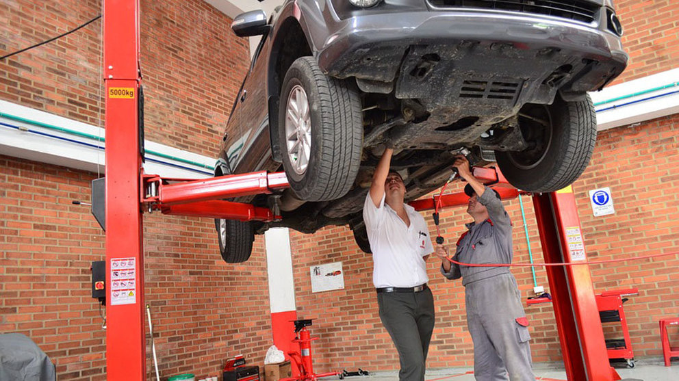 Un mecánico trabaja en la reparación de un coche en un taller ARCHIVO