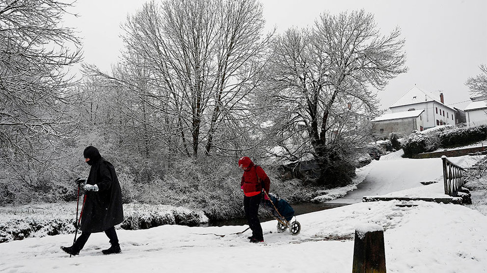 Pilgrims walk on the snow as they walk St James Way in Burguete, Navarra, Spain, 03 March 2020. After weeks of warm spring weather, the snow has surprised early flourished plants and trees as temperature lowers back to normal in this time of the year. EFE/ Jesus Diges
