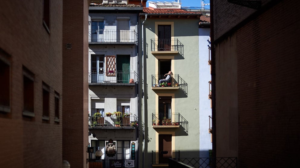 Un hombre toma el sol en el balcón de su casa durante la crisis por coronavirus en Pamplona. Miguel Osés