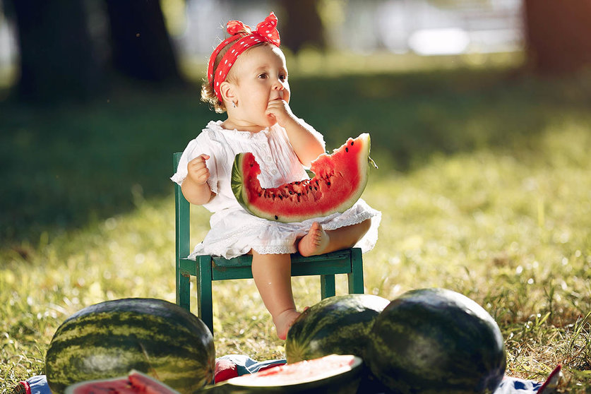 Child with a watermelons. Kids in a summer park