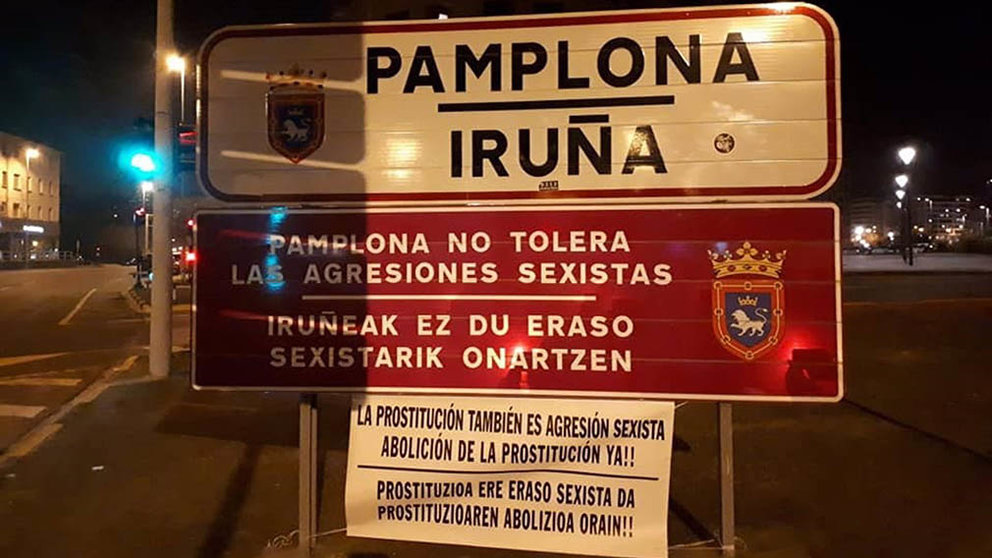 Cartel contra la prostitución colocado junto al cartel del Ayuntamiento de Pamplona contra las agresiones sexistas. PNAP