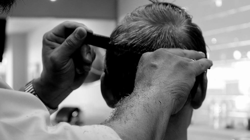 Un peluquero atiende a un hombre. ARCHIVO