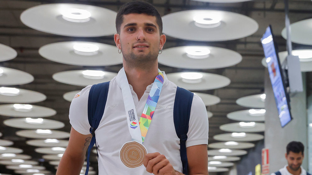 El atleta Asier Martínez (i) posa con su medallas de bronce conseguida en los Mundiales de Eugene (EE.UU) en los 1.500 metros y los 110 metros vallas respectivamente a su llegada este jueves al aeropuerto de Barajas en Madrid. EFE/ JuanJo Martin