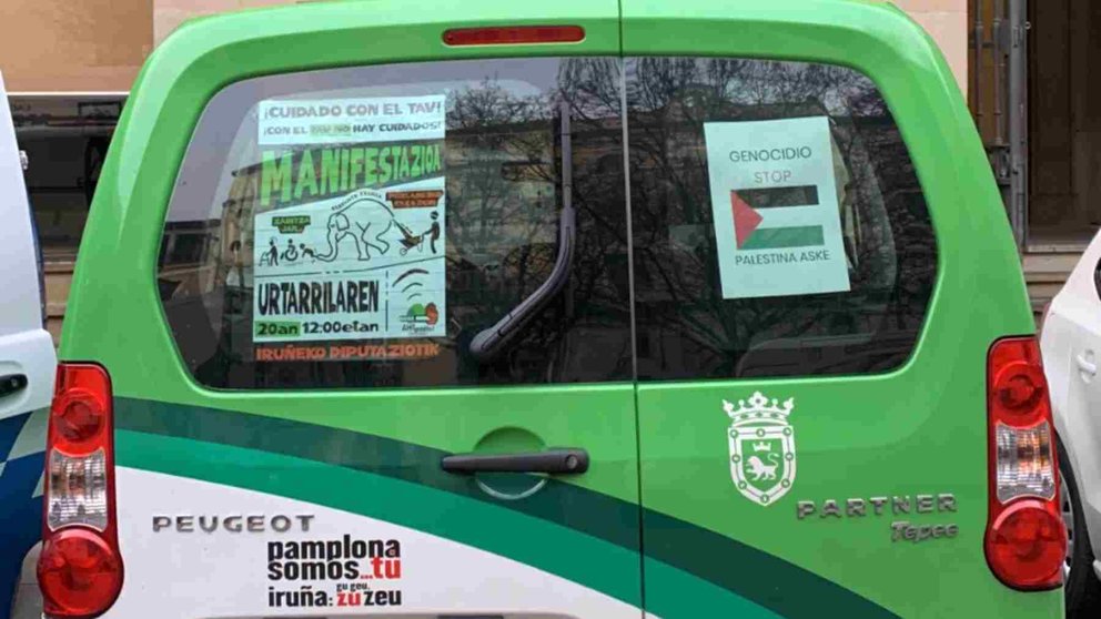 Vehículo municipal que muestra un cartel de una manifestación contra el Tren de Alta Velocidad y otro a favor de Palestina. UPN